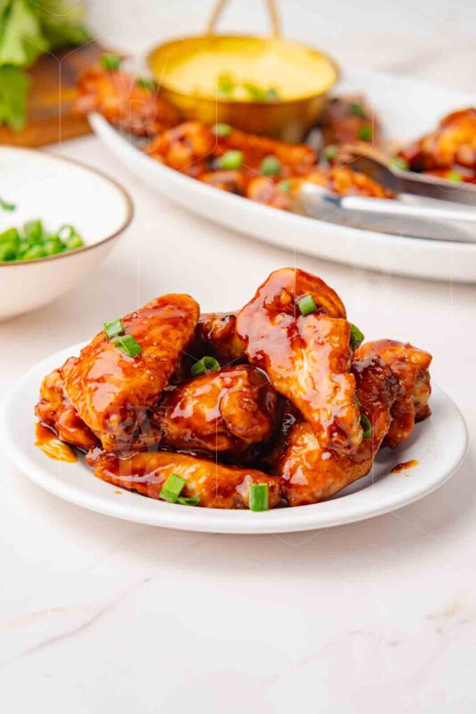 45 degree hero shot of a plate of honey BBQ chicken wings