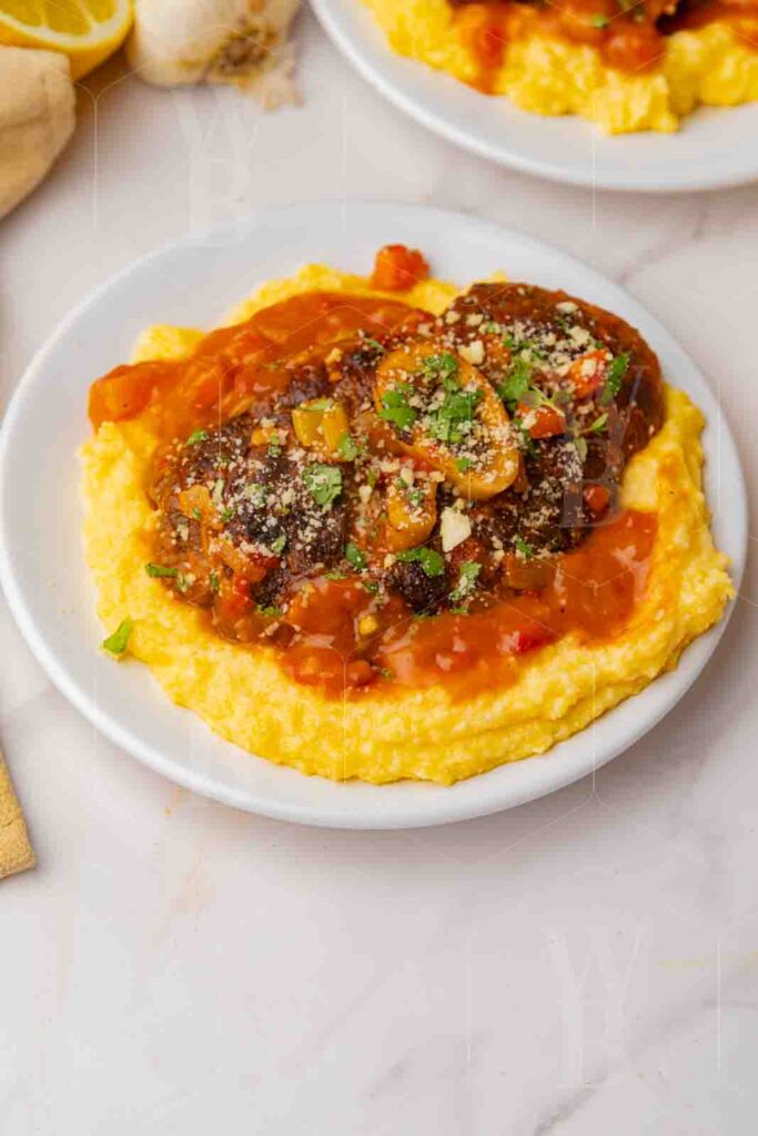 Pinterest pin size example: overhead hero shot of ossobuco with polenta on a white plate